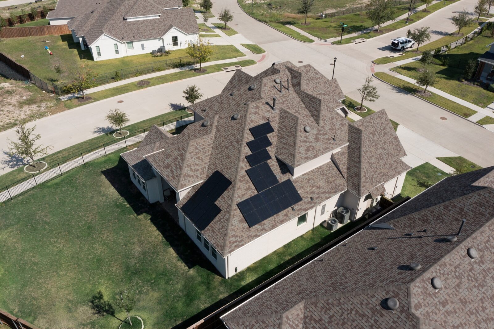 Aerial view of a completed Phase One roofing and solar project on a Texas home